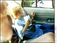 Nicholas Farber and his mother, Debra Rose, in a police car on Friday.